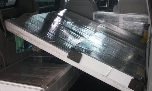 Transporting new vinyl replacement slider basement window
